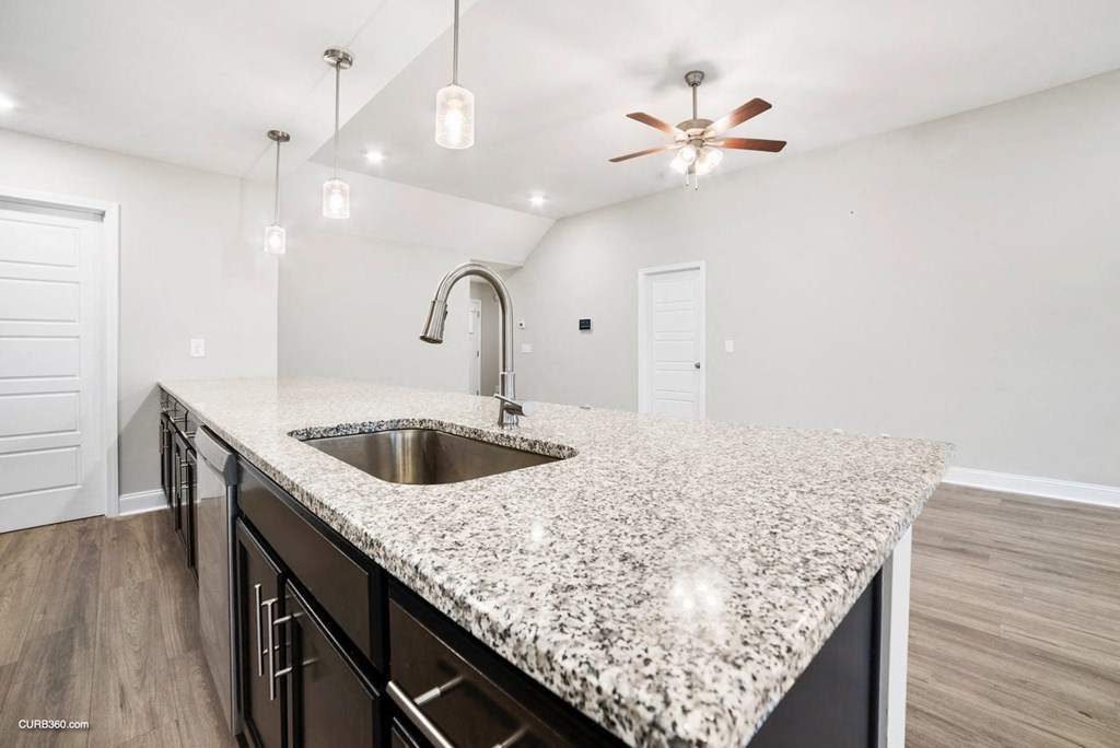 a kitchen with granite counter tops and a sink