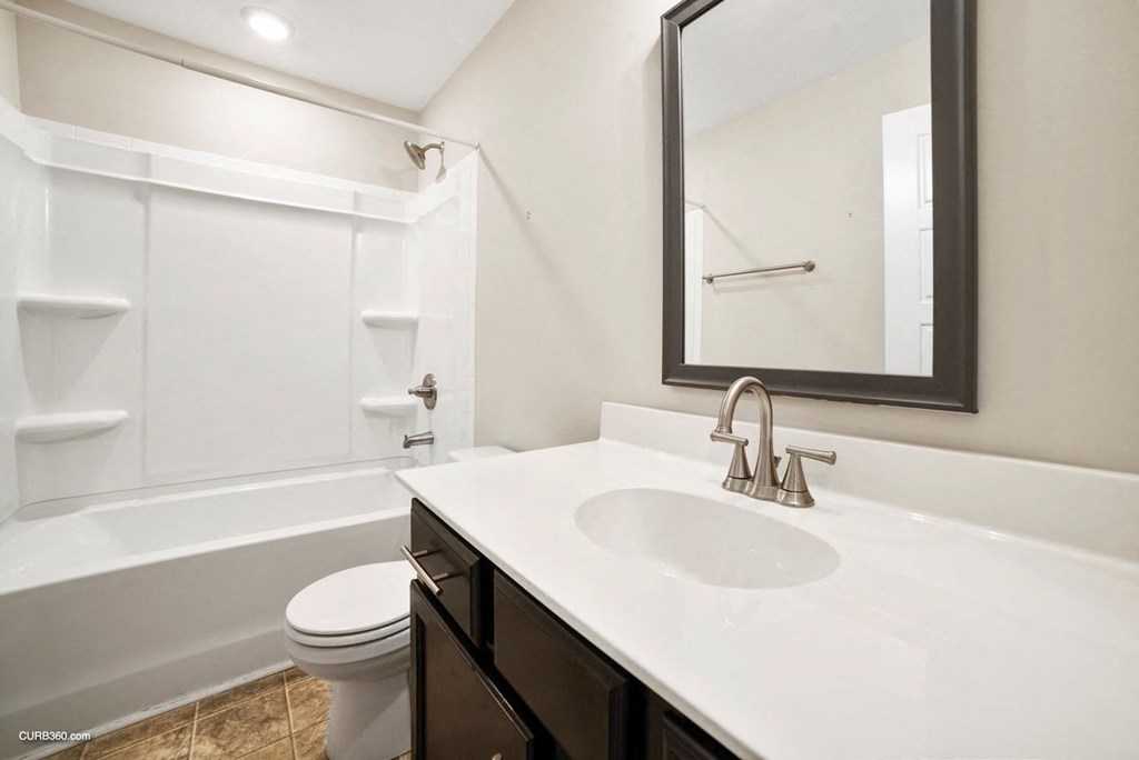 a bathroom with a sink and a toilet and a mirror