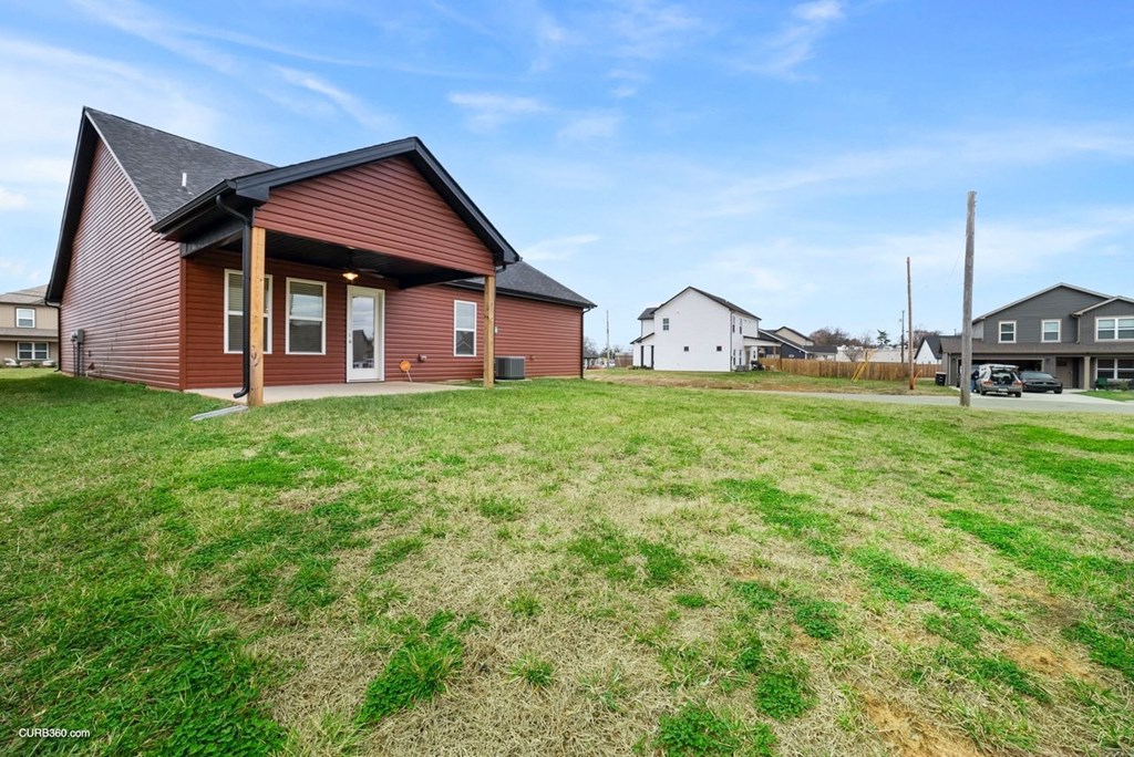 a red house with a yard in front of it