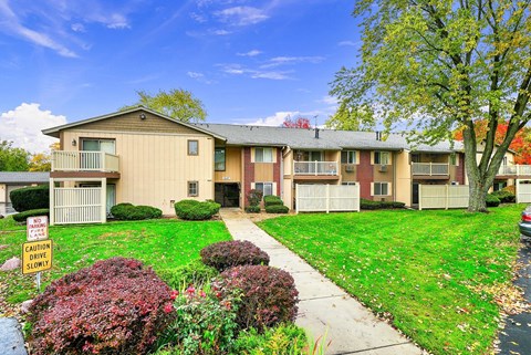 Apartment complex with a sign in front that says "CAUTION DRIVERS SHOULD NOT PARK HERE".