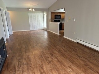 A living room with wood flooring and a television.