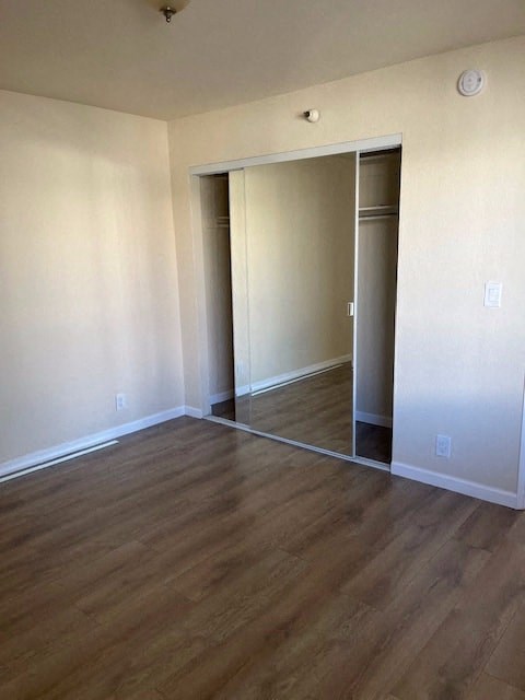 an empty living room with a hard wood floor