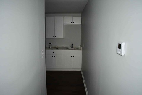 a kitchen with white cabinets and a sink