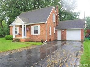 a red brick house with a white garage