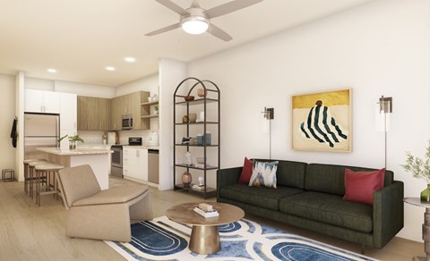 A living room with a green couch and a painting on the wall.
