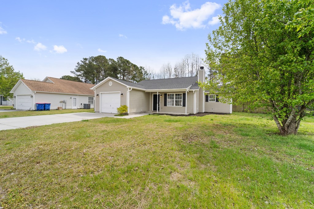 A house with a white garage door and a brown roof.