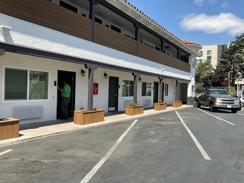 the front of a building with a car parked outside