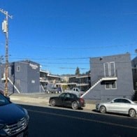 a street with cars parked in front of buildings