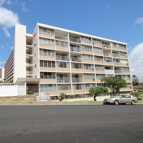 an image of an apartment building with a car parked in front