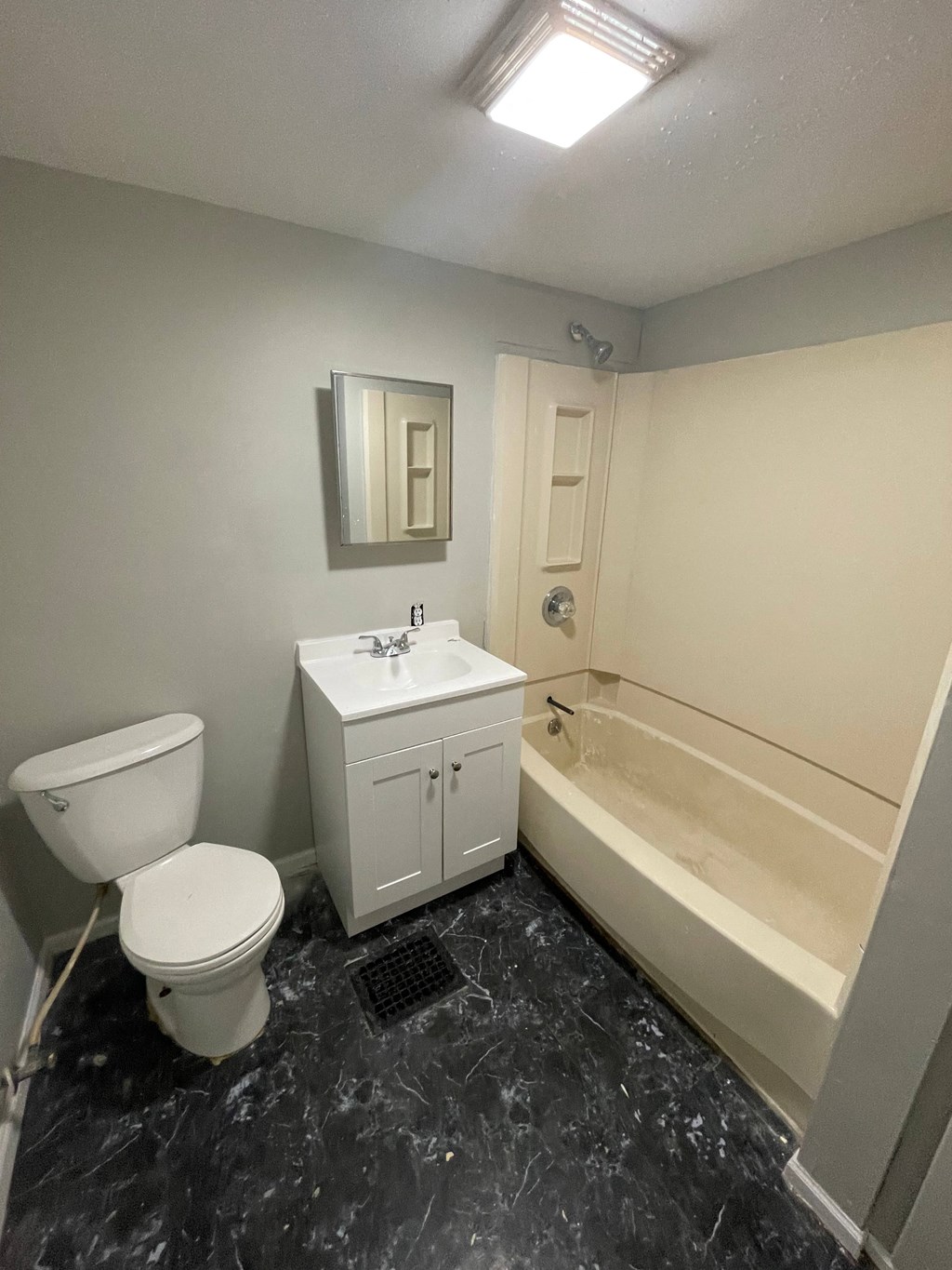 a bathroom with a toilet and a sink and a bath tub