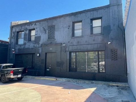 an old building with a truck parked in front of it