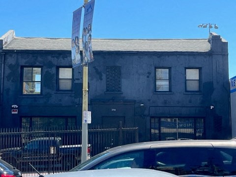 an old building with a car parked in front of it