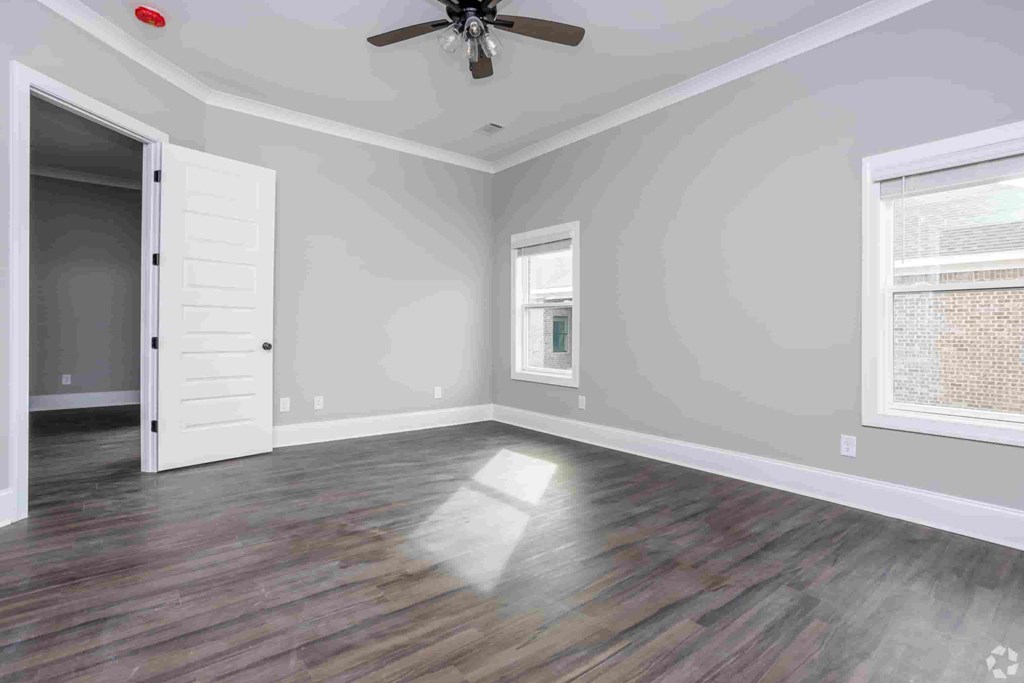 A room with a ceiling fan and a window.