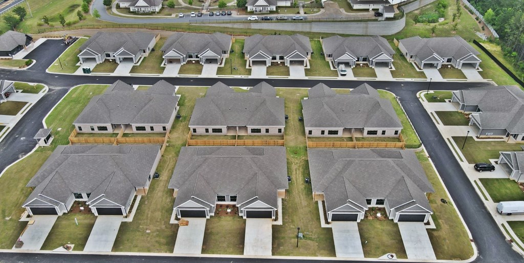 A bird's eye view of a residential neighborhood with houses and streets.