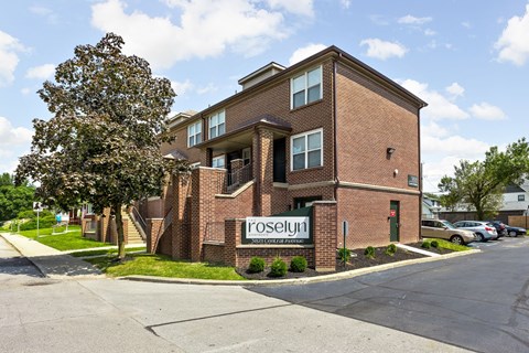 a brick building with a sign in front of it