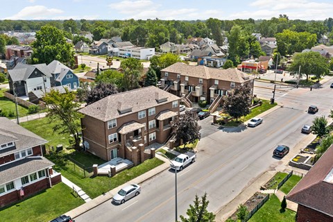 an aerial view of a neighborhood with houses and a street