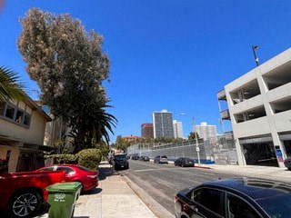a busy city street with cars parked on the side
