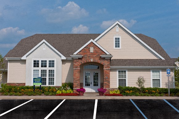 the front of a house with a parking lot