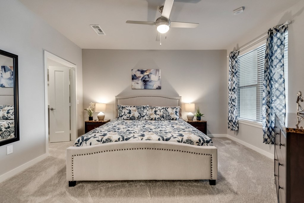 a bedroom with a bed and a ceiling fan