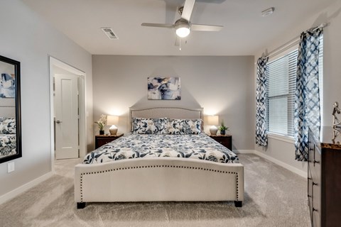 a bedroom with a bed and a ceiling fan