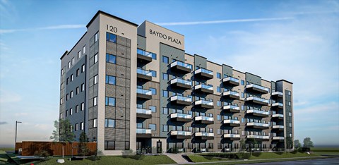 a large building with balconies and a blue sky in the background