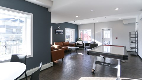A room with a pool table and a couch.