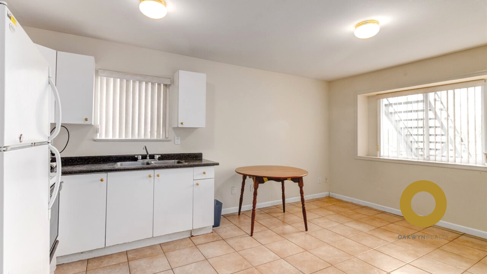 a kitchen with white cabinets and a sink and a table