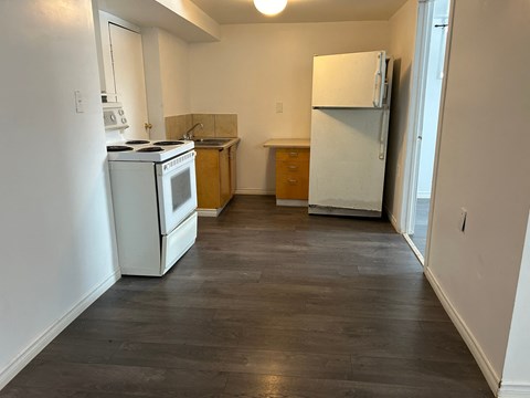 a kitchen with a stove and a refrigerator in it