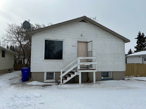 a small white house in the snow