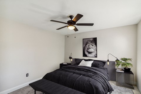 a bedroom with a bed and a ceiling fan