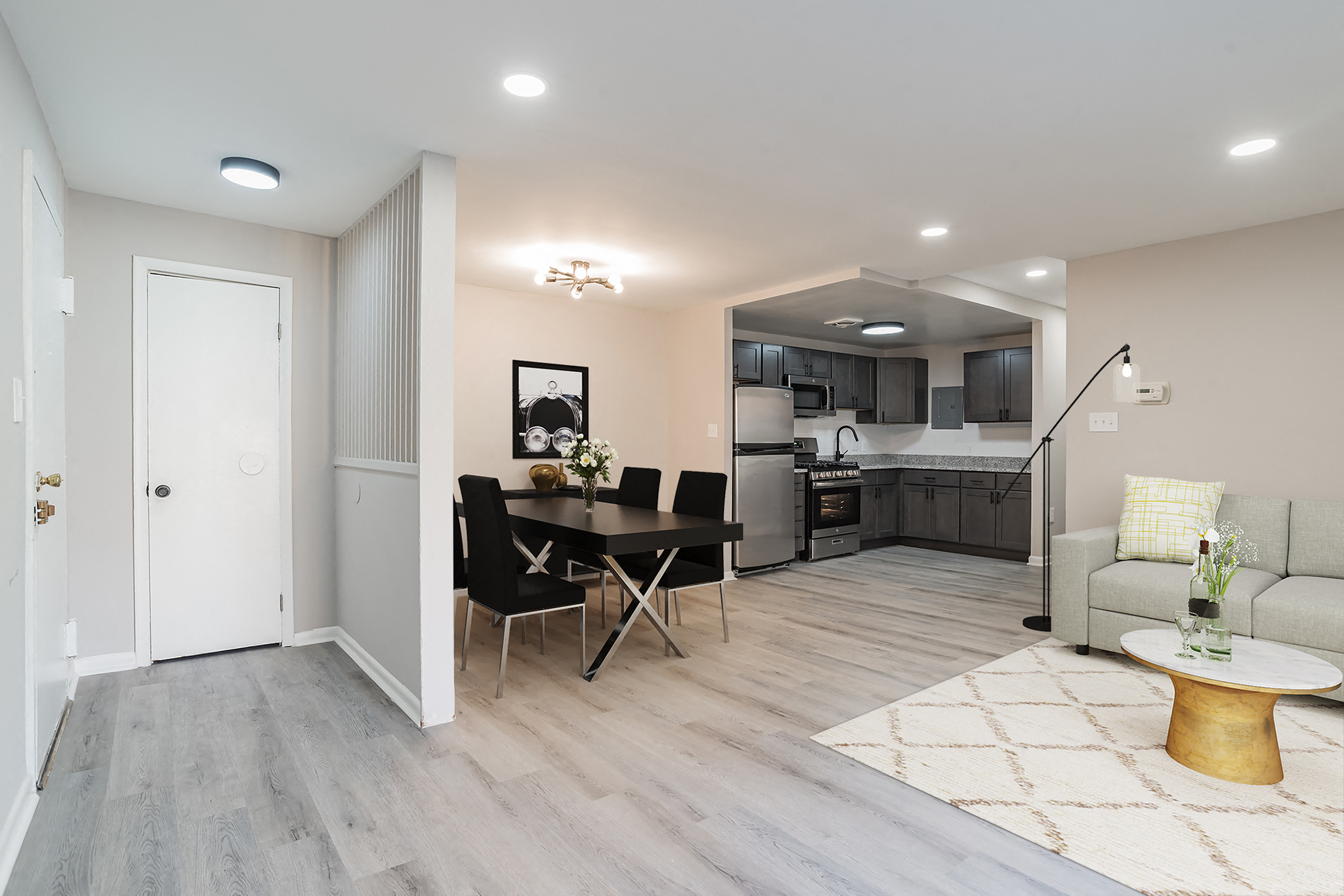 a living room and kitchen with a table and chairs