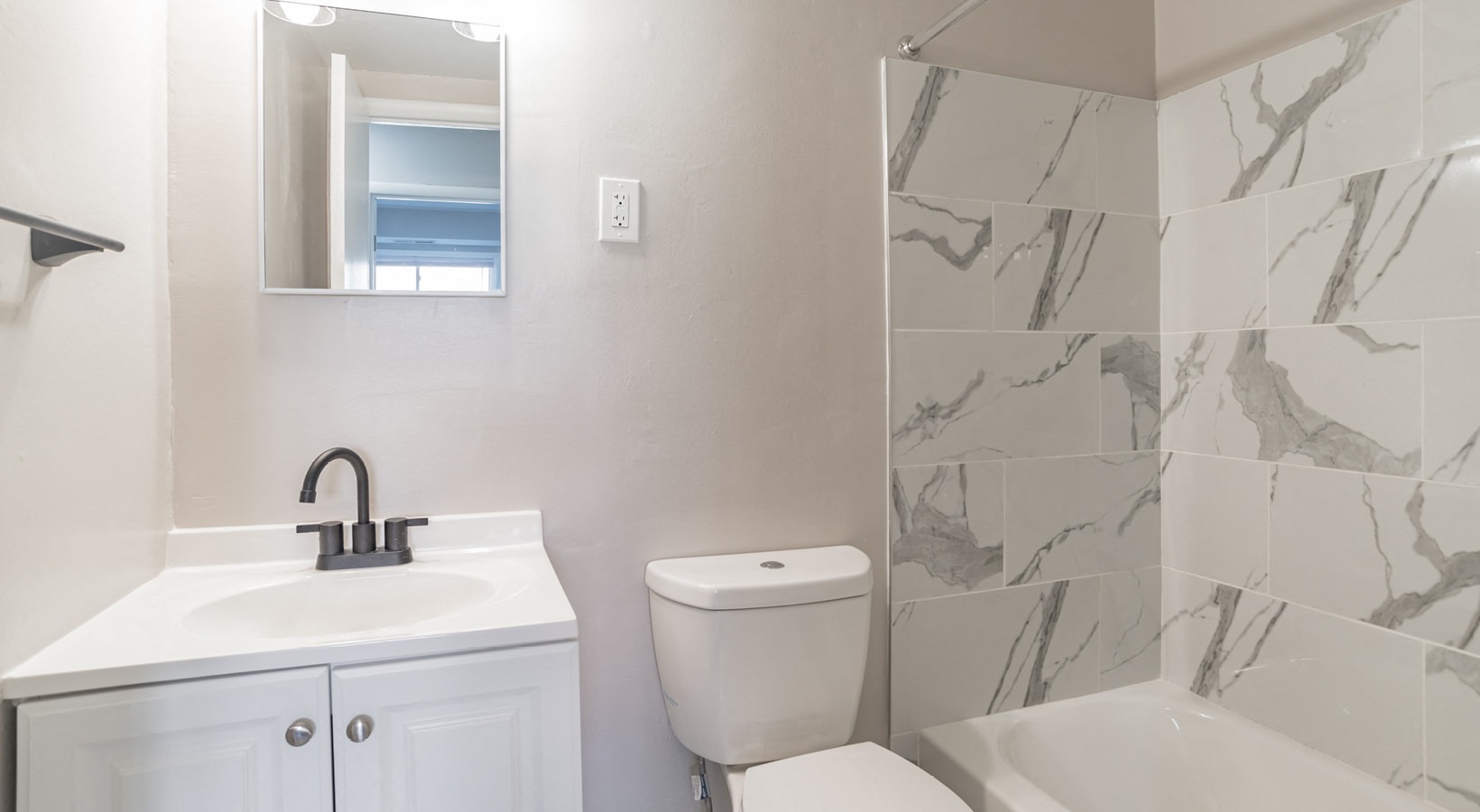a bathroom with a sink toilet and a mirror