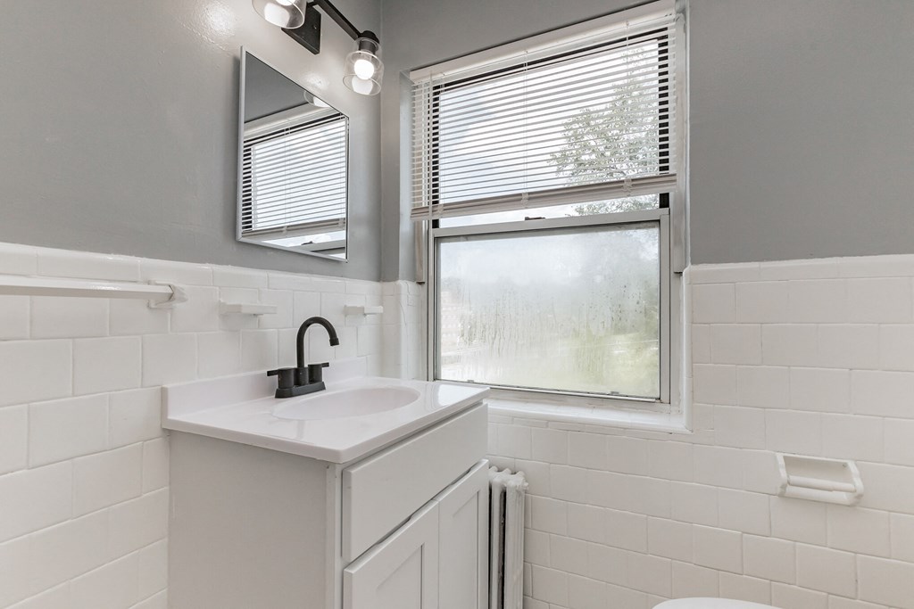 a small bathroom with a sink and a window
