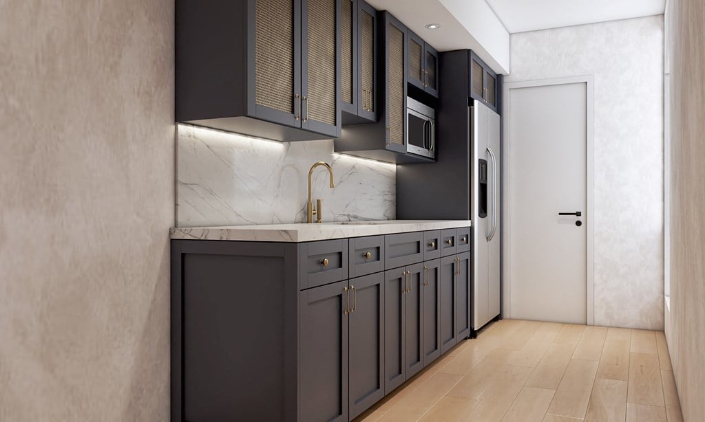 A modern kitchen with dark cabinets and a marble countertop.