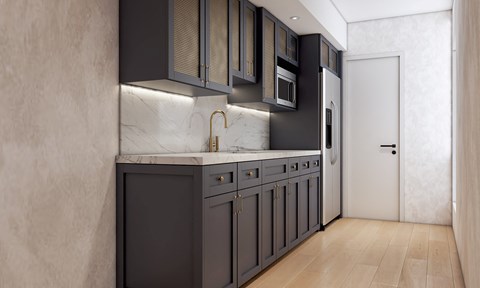A modern kitchen with dark cabinets and a marble countertop.