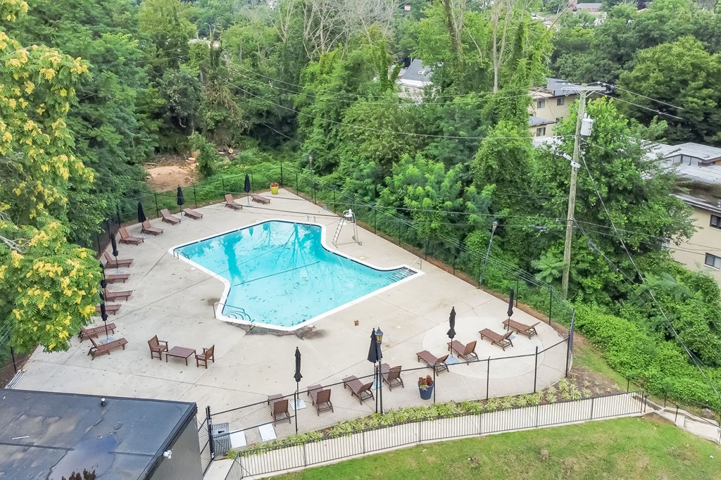 a swimming pool is surrounded by chairs and a resort pool