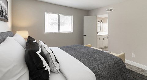 a bedroom with a large bed and a bathroom