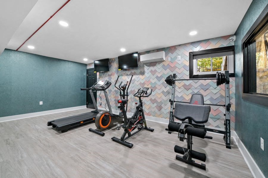 the gym in the home has a lot of exercise equipment