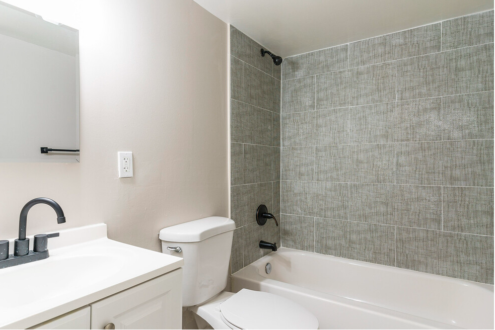 a bathroom with a sink toilet and a tub