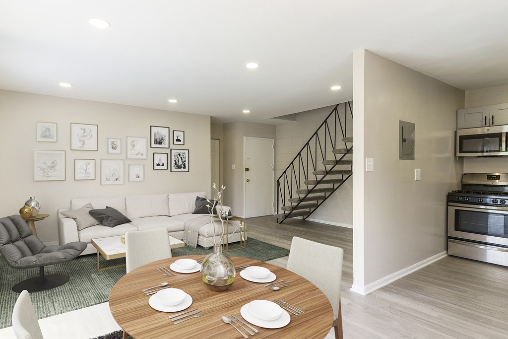 a living room and dining room with a wooden table