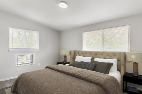 a bedroom with a bed and two windows