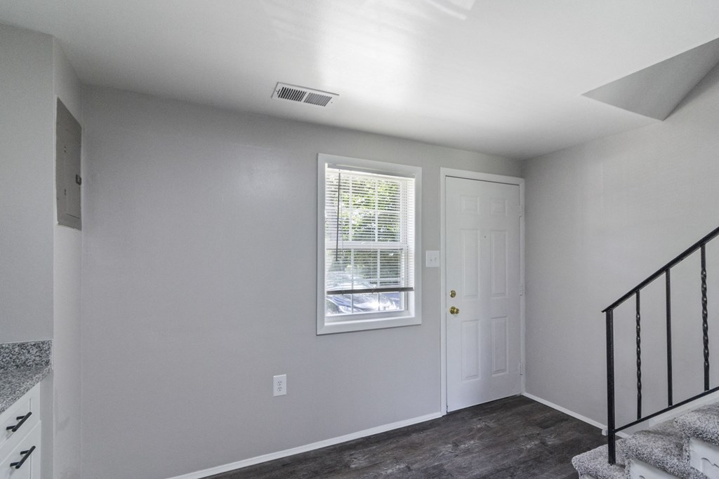 A room with a window and a door.