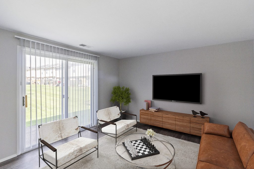 A living room with a television, two chairs, a couch, and a chess board on the coffee table.