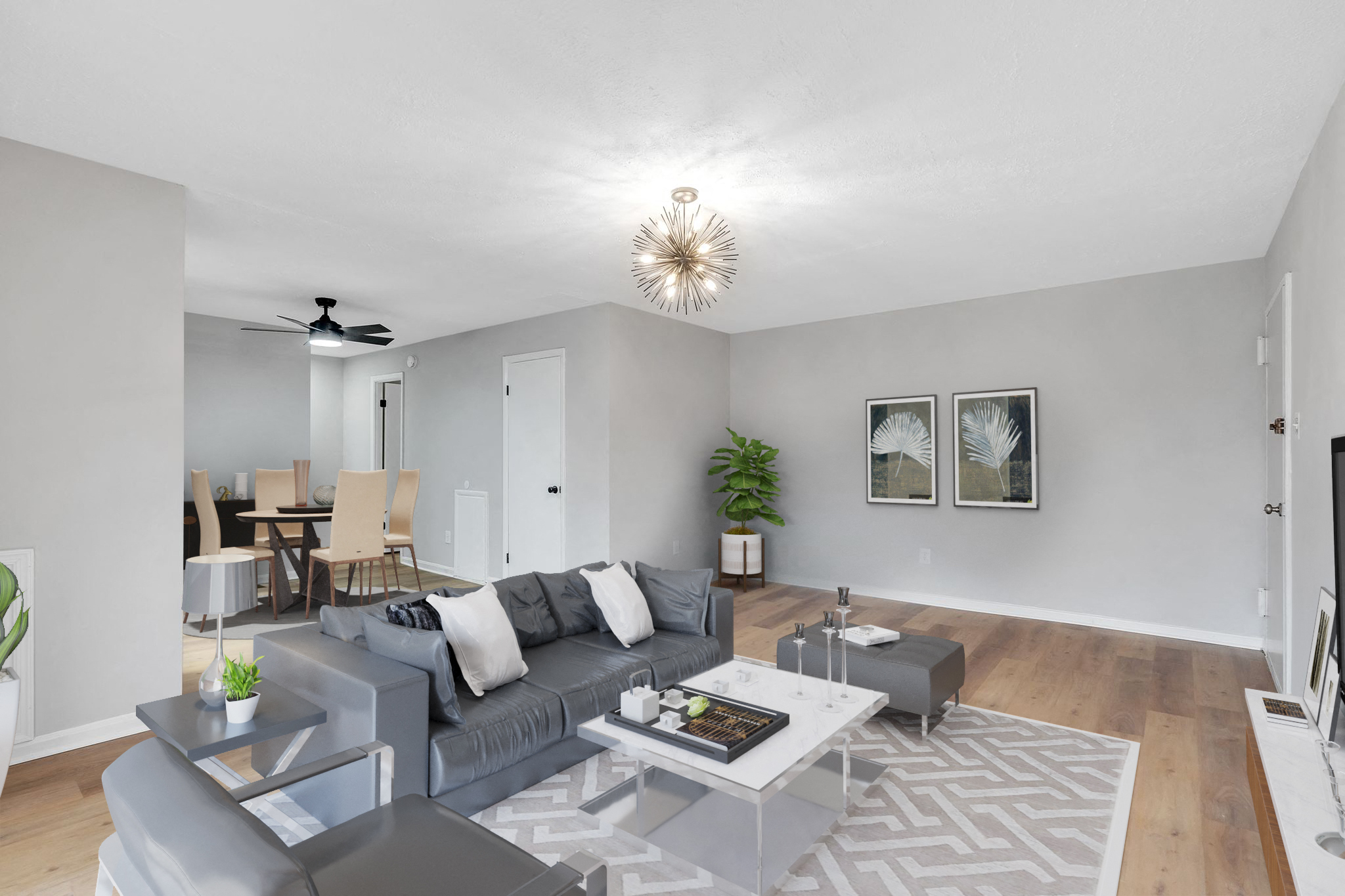 a living room with a gray couch and a white coffee table