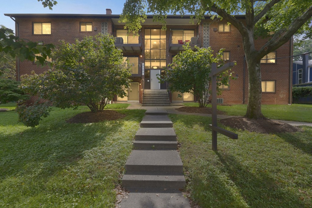A brick building with a tree in front of it.
