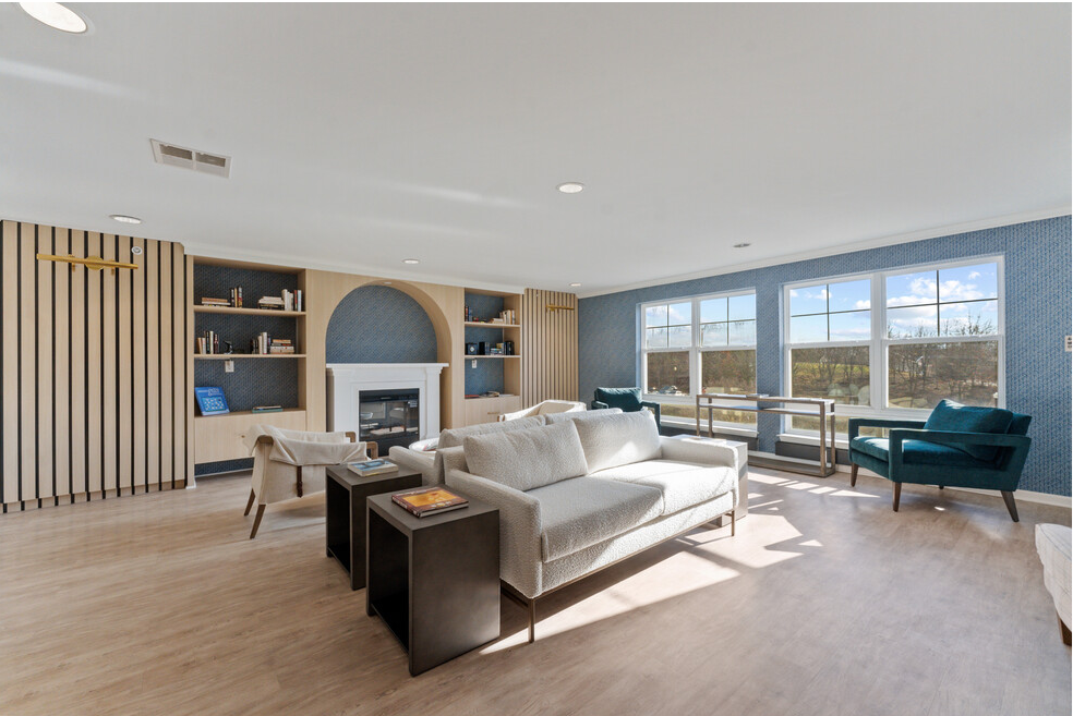 a living room with a couch and chairs and a fireplace