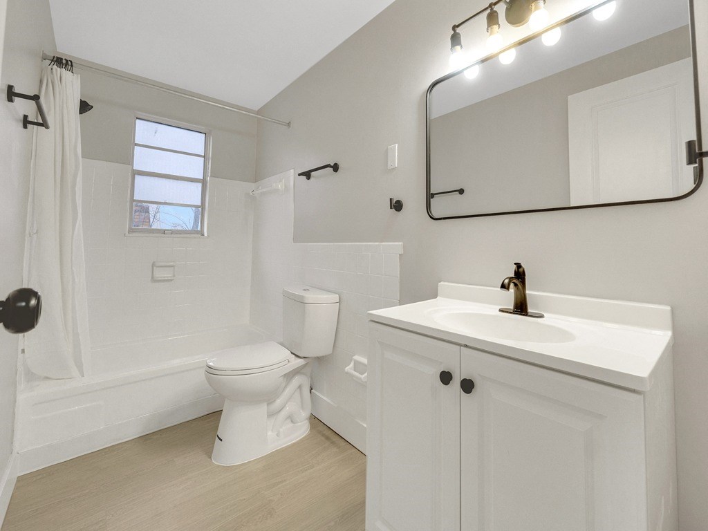 a bathroom with a sink toilet and a mirror