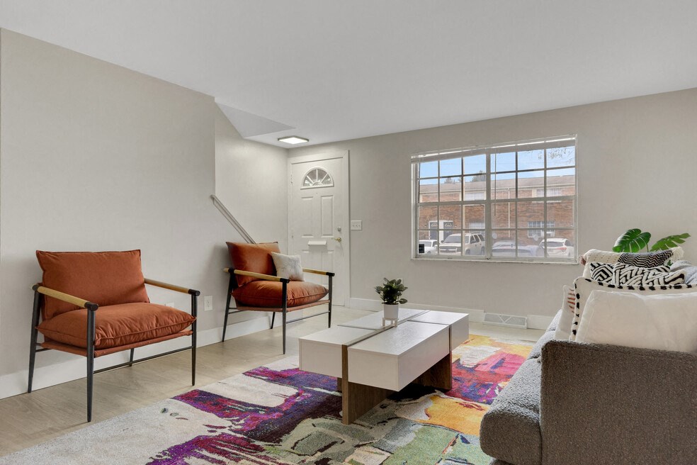 A living room with two chairs and a coffee table.