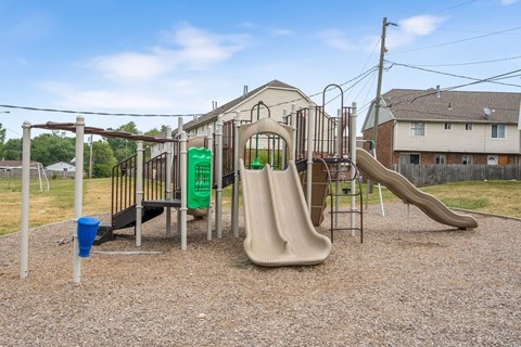 A playground with a slide, swings, and a climbing frame.