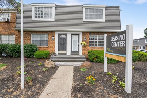 A house with a sign that says Leasing Center.